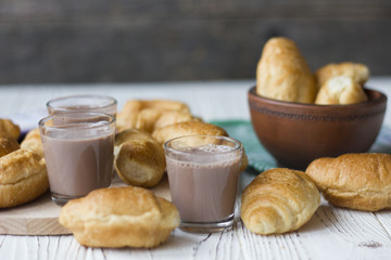 croissants and chocolate on white wooden table