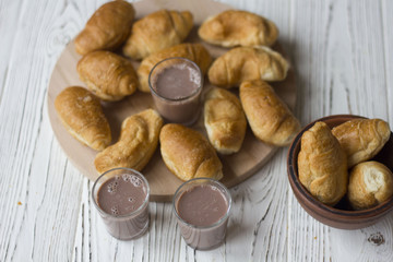 croissants and chocolate on white wooden table