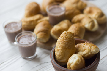croissants and chocolate on white wooden table