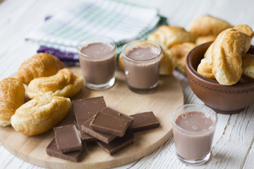 croissants and chocolate on white wooden table
