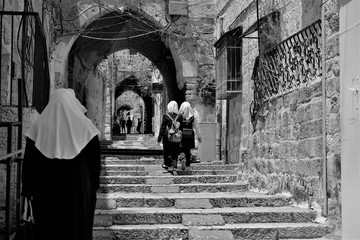 Religious pilgrims come from all over the world to Jerusalem during christmas and eastern, and follow the via dolorosa path that jesus christ  walked before crucifix