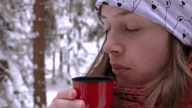 close up of women enjoy hot tea feel good in cold winter with snow