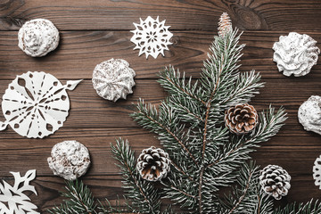 Brown wood background. Sweets. christmas decorations and new year. Fir tree and cones. Xmas and Happy New Year composition. Flat lay, top view