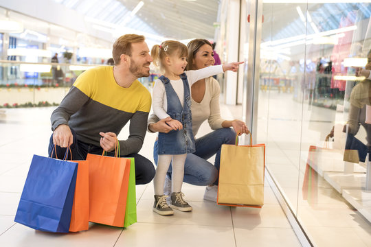 Happy Family With Child And Shopping Bags Doing Shopping 