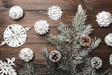 Brown wood background. Fir tree and cones. Sweets. christmas decorations and new year. Xmas and Happy New Year composition. Flat lay, top view