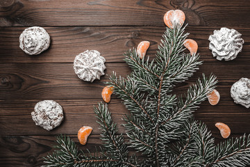 Brown wood background. Slice of mandarins. Sweets. Fir tree and cones. Christmas greeting card and new year. Xmas and Happy New Year composition. Flat lay, top view