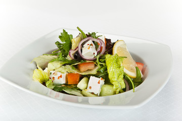 Greek salad with fresh vegetables, feta cheese and black olives