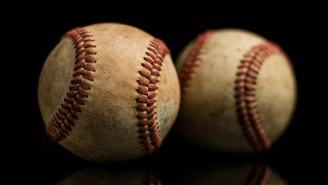 Two Baseball Balls On Black Background
