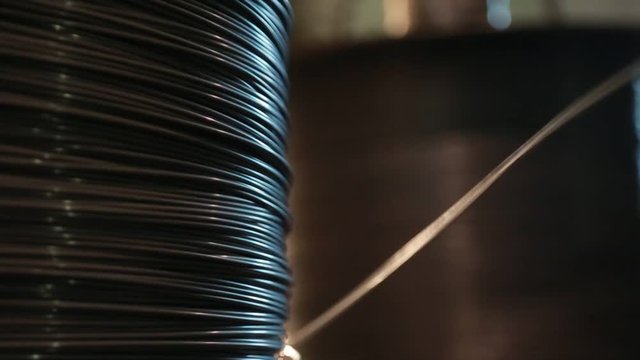 The large coil rotates and unwinds the wire