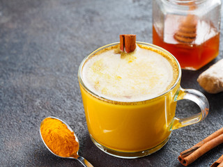 golden turmeric latte and ingredients, copy space