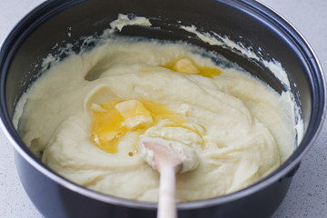 Some butter is melting in a creamy, steaming potato puree.