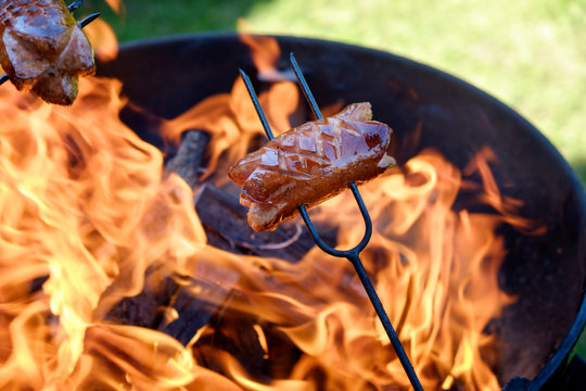 Preparing sausages on camp fire