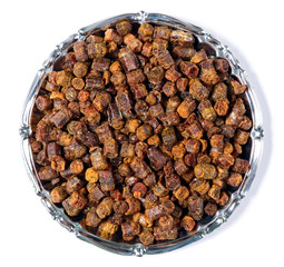 Propolis granules inside plate, bee product