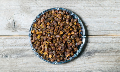 Propolis granules inside plate, bee product