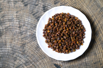 Propolis granules inside plate, bee product