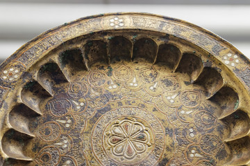 Ancient brass plate with patterns. Selective focus