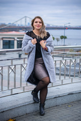 A woman of plus size, American or European appearance walks in the city enjoying life. A young lady...
