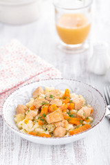 Braised chicken meat with carrot in sauce and pasta