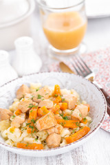 Braised chicken meat with carrot in sauce and pasta