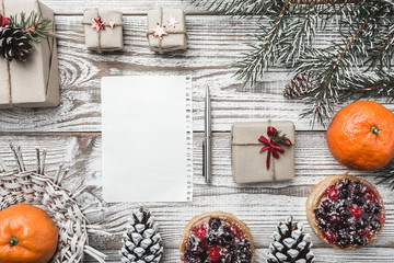 Winter card. Oranges. Pinecone. Fir branch. Fruit cakes. Space for lettering for Santa Claus or New Year. Xmas card. Stylish. Gifts. Snowflakes. Xmas and Happy New Year composition. Flat lay, top view