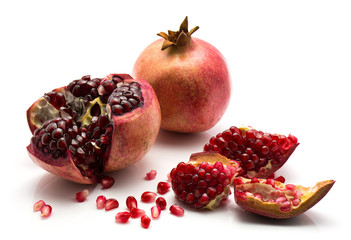 Split open pomegranate isolated on white background.