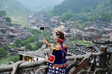 Peolple from different tribes in China dressed in traditional costumes, the miao tribe, dong tribe, gejia people, cormorant fishermen