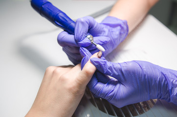 Manicurist master makes manicure