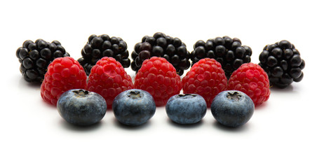 Berries isolated on white background blackberry blueberry and rasberry in row.