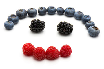 Heart by berries isolated on white background blackberry blueberry and raspberry.