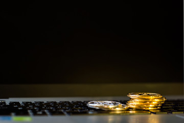 Silver and gold bitcoin on keyboard