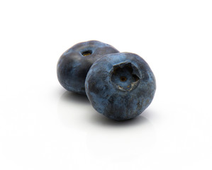 Two bog blueberries isolated on white background.