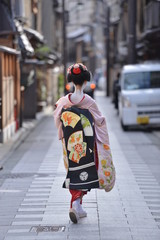 traditional japanese costumes kimono worn by a maiko with all the make up and tattos walking in the streets of gion corner kyoto japan