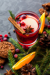 Winter cocktail grog, hot sangria, mulled wine. On dark table. 
