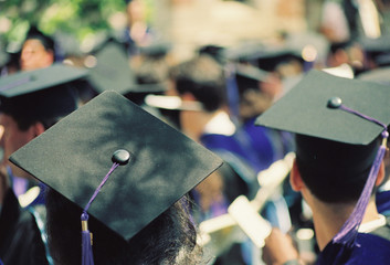 Graduates wearing black  hats at a final college ceremony
