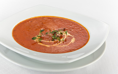 fresh tomato soup with cream in a plate