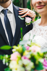 girl, woman in a long white dress with a wedding bouquet along with a bearded bridegroom after a wedding ceremony on a walk in an exotic autumn park.