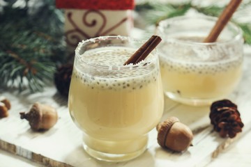 Eggnog with chia seeds- Xmas Holiday drink on festive background, selective focus