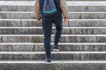 young man climbs the stairs
