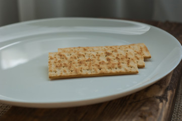 several cookies cracker on a white plate on a wooden background