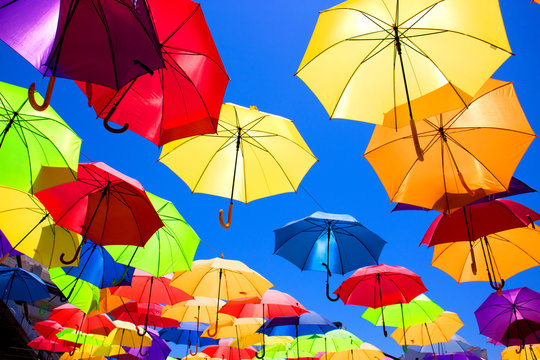 Multicolor umbrellas. Street art. Puerto Banus city, Marbella, Andalusia, Spain.
