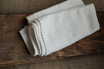 Fototapeta na wymiar White kitchen towel on a wooden surface.