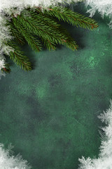 New year green background. New Year decoration with snowflakes and cones. Happy New Year and Merry Christmas!