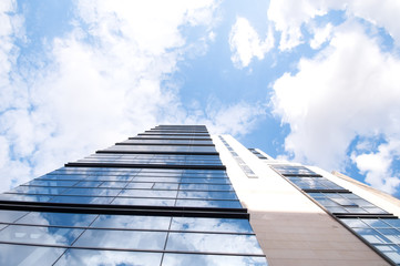 Glass building and blue sky with clouds