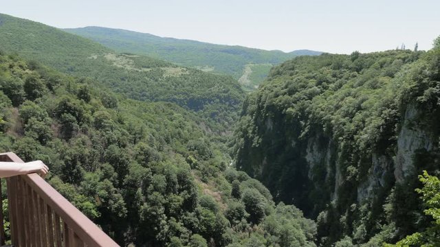 Young woman walks on observation deck. Okatse Canyon, near Kutaisi, Georgia