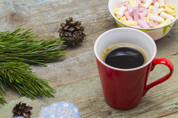 Christmas background with fir tree, cup of coffee on a wooden table
