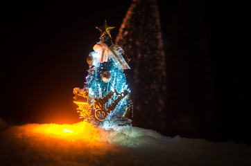 Christmas background with snowy fir trees. Snow Covered Christmas Tree stands out brightly against the dark blue tones of this snow covered scene. Toned dark background