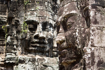Stone faces in the Bayon temple ruins of Angkor Wat in Cambodia