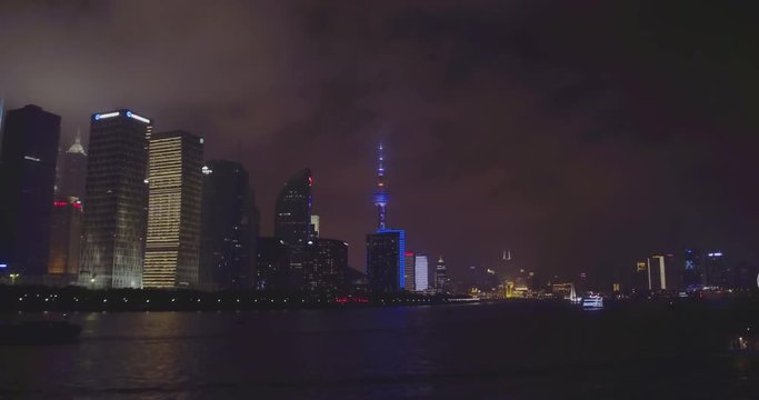 SHANGHAI, CHINA – JUNE 2016 : Video shot on Huangpu River of skyline at night with Oriental Pearl TV Tower in view