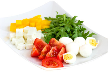 ingredients for a salad on a plate on a white background.