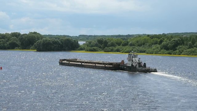 Top view of seascape - empty barge without cargo float along the river in summer sunny day